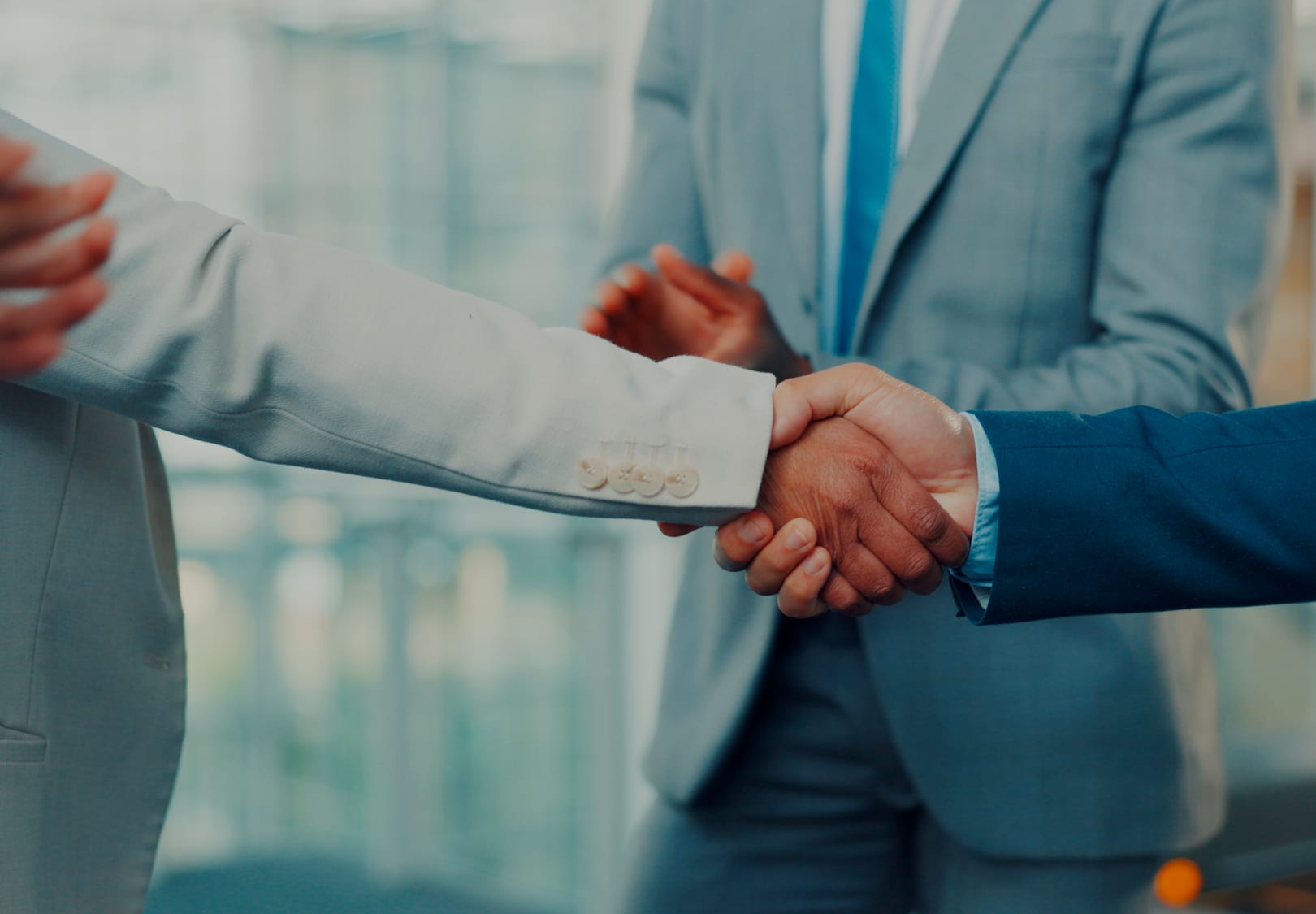 Two colleagues shaking hands in an office