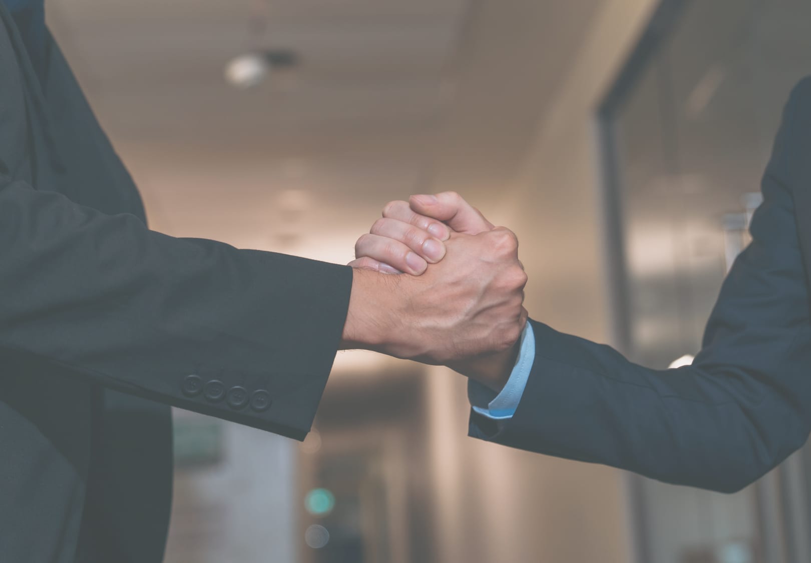Two people shaking hands after a business agreement